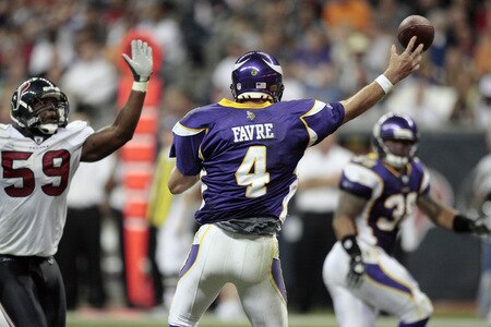 HOUSTON - AUGUST 31:  Quarterback Brett Favre #4 of the Minnesota Vikings releases a pass as he is pressured by linebacker DeMeco Ryans #59 of the Houston Texans at Reliant Stadium on August 31, 2009 in Houston, Texas.  <br /><br /><span class="help">(Photo by Bob Levey/Getty Images)</span>