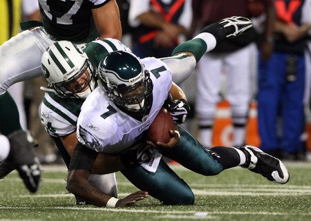 EAST RUTHERFORD, NJ - SEPTEMBER 03:  Michael Vick #7 of the Philadelphia Eagles is tackled by Kenwin Cummings #54 of the New York Jets on September 3, 2009 at Giants Stadium in East Rutherford, New Jersey. The Jets defeated the Eagles 38-27.  <br /><br /><span class="help">(Photo by Jim McIsaac/Getty Images)</span>