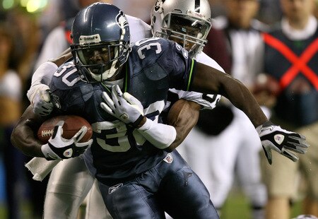 SEATTLE - SEPTEMBER 03:  Running back Devin Moore #30 of the Seattle Seahawks rushes against Darrick Brown #39 of the Oakland Raiders on September 3, 2009 at Qwest Field in Seattle, Washington. The Seahawks defeated the Raiders 31-21. <br /><br /><span class="help">(Photo by Otto Greule Jr/Getty Images)</span>