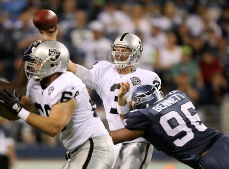 SEATTLE - SEPTEMBER 03:  Quarterback Charlie Frye #3 of the Oakland Raiders passes as he is hit by Michael Bennett #96 of the Seattle Seahawks on September 3, 2009 at Qwest Field in Seattle, Washington. The Seahawks defeated the Raiders 31-21. <br /><br /><span class="help">(Photo by Otto Greule Jr/Getty Images)</span>