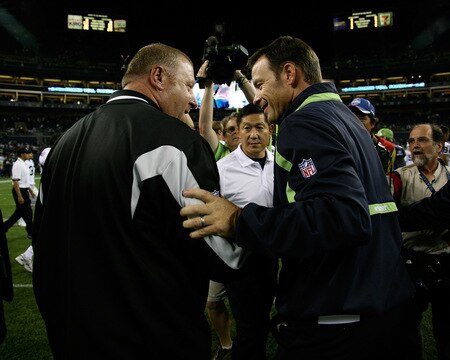 SEATTLE - SEPTEMBER 03:  Head coach Tom Cable (L) of the Oakland Raiders meets with head coach Jim Mora of the Seattle Seahawks after the game on September 3, 2009 at Qwest Field in Seattle, Washington. The Seahawks defeated the Raiders 31-21. <br /><br /><span class="help">(Photo by Otto Greule Jr/Getty Images)</span>