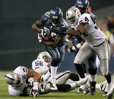 SEATTLE - SEPTEMBER 03:  Running back Devin Moore #30 of the Seattle Seahawks rushes against Sam Williams #54 of the Oakland Raiders on September 3, 2009 at Qwest Field in Seattle, Washington. The Seahawks defeated the Raiders 31-21. <br /><br /><span class="help">(Photo by Otto Greule Jr/Getty Images)</span>