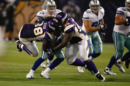 MINNEAPOLIS, MN - SEPTEMBER 4: Fred Evans #90 and Letroy Guion #98 of the Minnesota Vikings sack quarterback Rudy Carpenter #5 of the Dallas Cowboys at Hubert H. Humphrey Metrodome on September 4, 2009 in Minneapolis, Minnesota. The Cowboys defeated the Vikings 35-31. <br /><br /><span class="help">(Photo by Scott Boehm/Getty Images)</span>