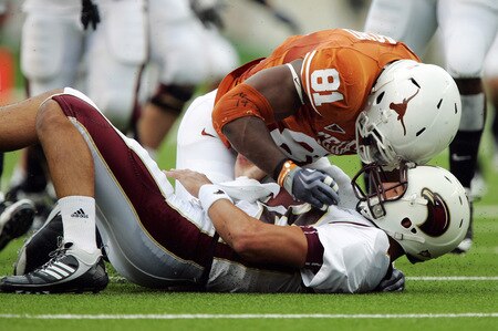 AUSTIN, TX - SEPTEMBER 5:  Defensive end Sam Acho #81 of the Texas Longhorns knocks the ball away from quarterback Trey Revell #12 of the Louisiana Monroe Warhawks for a turnover as he sacks him on September 5, 2009 at Darrell K Royal-Texas Memorial Stadium in Austin, Texas.  The Longhorns scored on the drive. <br /><br /><span class="help">(Photo by Brian Bahr/Getty Images)</span>