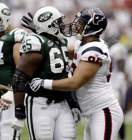 HOUSTON - SEPTEMBER 13:  Guard Brandon Moore #65 of the New York Jets and defensive tackle Shaun Cody #95 of the Houston Texans exchange words at Reliant Stadium on September 13, 2009 in Houston, Texas.  <br /><br /><span class="help">(Photo by Bob Levey/Getty Images)</span>