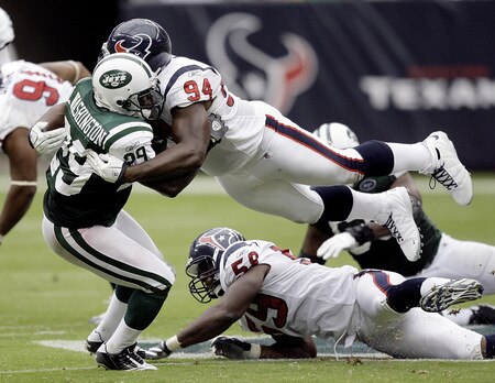 HOUSTON - SEPTEMBER 13:  Running back Leon Washington #29 of the New York Jets is tackled by defensive end Antonio Smith #94 of the Houston Texans in the second quarter at Reliant Stadium on September 13, 2009 in Houston, Texas.  <br /><br /><span class="help">(Photo by Bob Levey/Getty Images)</span>