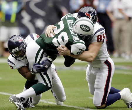 HOUSTON - SEPTEMBER 13: Leon Washington #29 of the New York Jets is tackled by Joel Dreesen #85 of the Houston Texans and Antwaun Molden #28 on a punt return at Reliant Stadium on September 13, 2009 in Houston, Texas.  <br /><br /><span class="help">(Photo by Bob Levey/Getty Images)</span>