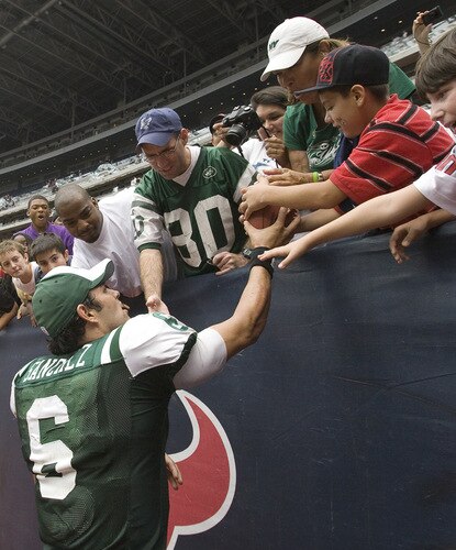 HOUSTON - SEPTEMBER 13:  Quarterback Mark Sanchez #6 of the New York Jets gives the game ball to a fan after his 24-7 win over the Houston Texans at Reliant Stadium on September 13, 2009 in Houston, Texas.  <br /><br /><span class="help">(Photo by Bob Levey/Getty Images)</span>