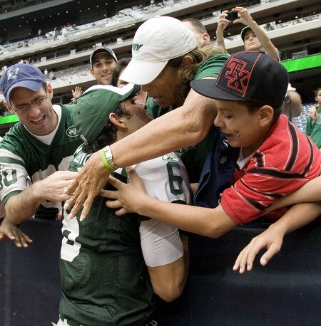 HOUSTON - SEPTEMBER 13:  Quarterback Mark Sanchez #6 of the New York Jets gives the game ball to a fan after his 24-7 win over the Houston Texans at Reliant Stadium on September 13, 2009 in Houston, Texas.  <br /><br /><span class="help">(Photo by Bob Levey/Getty Images)</span>