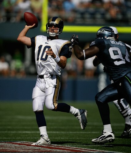 SEATTLE - SEPTEMBER 13:  Quarterback Marc Bulger #10 of the St. Louis Rams passes against Cory Redding #94 of the Seattle Seahawks on September 13, 2009 at Qwest Field in Seattle, Washington. <br /><br /><span class="help">(Photo by Otto Greule Jr/Getty Images)</span>