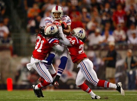 FOXBORO, MA - SEPTEMBER 14:  Wide receiver Josh Reed #82 of the Buffalo Bills complete a pass between Brandon Meriweather #31 and Jonathan Wilhite #24 of the New England Patriots during the first quarter of the game on September 14, 2009 at Gillette Stadium in Foxboro, Massachusetts. <br /><br /><span class="help">(Photo by Jim Rogash/Getty Images)</span>