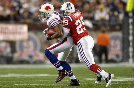 FOXBORO, MA - SEPTEMBER 14:  Lee Evans #83 of the Buffalo Bills is tackled by Shawn Springs #29 of the New England Patriots on September 14, 2009 at Gillette Stadium in Foxboro, Massachusetts. <br /><br /><span class="help">(Photo by Elsa/Getty Images)</span>