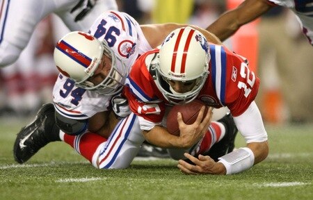 FOXBORO, MA - SEPTEMBER 14:  Quarterback Tom Brady #12 of the New England Patriots is sacked by Aaron Schobel #94 of the Buffalo Bills on September 14, 2009 at Gillette Stadium in Foxboro, Massachusetts. <br /><br /><span class="help">(Photo by Elsa/Getty Images)</span>