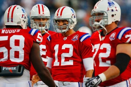 FOXBORO, MA - SEPTEMBER 14:  Quarterback Tom Brady #12 of the New England Patriots meets with teammates during the first quarter of the game against the Buffalo Bills on September 14, 2009 at Gillette Stadium in Foxboro, Massachusetts. <br /><br /><span class="help">(Photo by Jim Rogash/Getty Images)</span>
