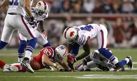 FOXBORO, MA - SEPTEMBER 14:  Wes Welker #83 of the New England Patriots reaches for a loose ball against Bryan Scott #43 and Leodis McKelvin #28 of the Buffalo Bills on September 14, 2009 at Gillette Stadium in Foxboro, Massachusetts. <br /><br /><span class="help">(Photo by Elsa/Getty Images)</span>