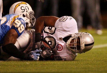 OAKLAND, CA - SEPTEMBER 14:  Michael Bush #29 of the Oakland Raiders scores on a 4-yard rushing touchdown in the first quarter against Kevin Burnett #99 of the San Diego Chargers on September 14, 2009 at the Oakland-Alameda County Coliseum in Oakland, California.  <br /><br /><span class="help">(Photo by Ezra Shaw/Getty Images)</span>