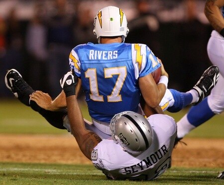 OAKLAND, CA - SEPTEMBER 14:  Philip Rivers #17 of the San Diego Chargers is sacked by Richard Seymour #92 of the Oakland Raiders on September 14, 2009 at the Oakland-Alameda County Coliseum in Oakland, California.  <br /><br /><span class="help">(Photo by Ezra Shaw/Getty Images)</span>