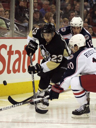 PITTSBURGH, PA - SEPTEMBER 15:  Chris Conner #23 of the Pittsburgh Penguins battles for the puck against Kris Russell #10 and Michael Blunden #12 of the Columbus Blue Jackets in the second period at Mellon Arena on September 15, 2009 in Pittsburgh, Pennsylvania.  <br /><br /><span class="help">(Photo by Justin K. Aller/Getty Images)</span>