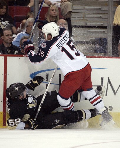 PITTSBURGH, PA - SEPTEMBER 15:  Derek Dorsett #15 of the Columbus Blue Jackets checks Simon Despres #59 of the Pittsburgh Penguins in the first period at Mellon Arena on September 15, 2009 in Pittsburgh, Pennsylvania.  <br /><br /><span class="help">(Photo by Justin K. Aller/Getty Images)</span>