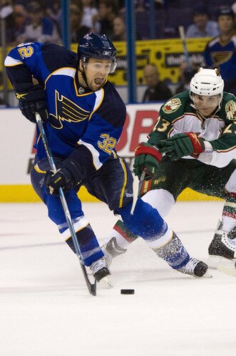 ST. LOUIS, MO. - SEPTEMBER 15: Chris Porter #32 of the St. Louis Blues moves the puck up ice against Petr Kalus #23 of the Minnesota Wild at the Scottrade Center on September 15, 2009 in St. Louis, Missouri.  <br /><br /><span class="help">(Photo by Dilip Vishwanat/Getty Images)</span>