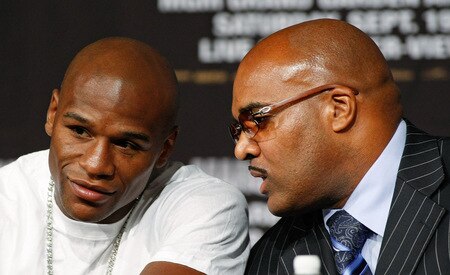 LAS VEGAS - SEPTEMBER 16:  Boxer Floyd Mayweather Jr. (L) and his advisor Leonard Ellerbe confer during the final news conference for Mayweather's bout against Juan Manuel Marquez at the MGM Grand Hotel/Casino September 16, 2009 in Las Vegas, Nevada. Mayweather and Marquez will fight at the MGM Grand Garden Arena on September 19 in Las Vegas.  <br /><br /><span class="help">(Photo by Ethan Miller/Getty Images)</span>