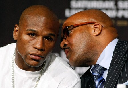 LAS VEGAS - SEPTEMBER 16:  Boxer Floyd Mayweather Jr. (L) and his advisor Leonard Ellerbe confer during the final news conference for Mayweather's bout against Juan Manuel Marquez at the MGM Grand Hotel/Casino September 16, 2009 in Las Vegas, Nevada. Mayweather and Marquez will fight at the MGM Grand Garden Arena on September 19 in Las Vegas.  <br /><br /><span class="help">(Photo by Ethan Miller/Getty Images)</span>