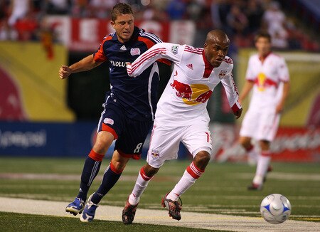 EAST RUTHERFORD, NJ - SEPTEMBER 18:  Dane Richards #19 of the New York Red Bulls plays the ball against Chris Tierney #8 of the New England Revolution at Giants Stadium in the Meadowlands on September 18, 2009 in East Rutherford, New Jersey. Revolution and Red Bulls play to a 1-1 tie  <br /><br /><span class="help">(Photo by Mike Stobe/Getty Images for New York Red Bull)</span>