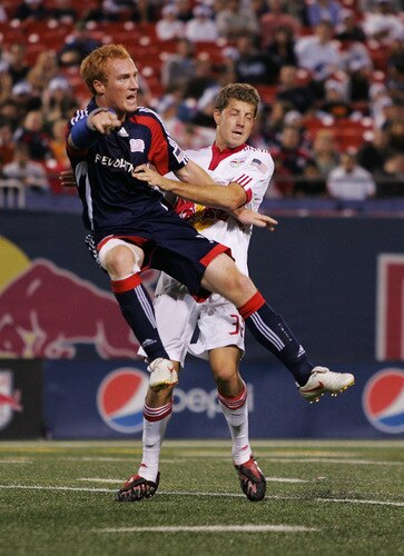 EAST RUTHERFORD, NJ - SEPTEMBER 18:  Luke Sassano #32 of the New York Red Bulls and Jeff Larentowicz #13 of the New England Revolution get tangled up at midfield at Giants Stadium in the Meadowlands on September 18, 2009 in East Rutherford, New Jersey. Revolution and Red Bulls play to a 1-1 tie  <br /><br /><span class="help">(Photo by Mike Stobe/Getty Images for New York Red Bull)</span>