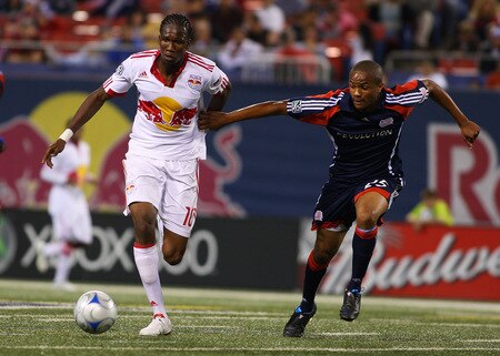 EAST RUTHERFORD, NJ - SEPTEMBER 18:  Macoumba Kandji #10 of the New York Red Bulls plays the ball against Darrius Barne #25 of the New England Revolution at Giants Stadium in the Meadowlands on September 18, 2009 in East Rutherford, New Jersey. Revolution and Red Bulls play to a 1-1 tie  <br /><br /><span class="help">(Photo by Mike Stobe/Getty Images for New York Red Bull)</span>