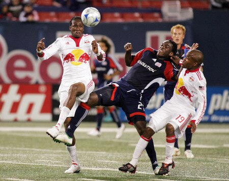 EAST RUTHERFORD, NJ - SEPTEMBER 18: Macoumba Kandji #10 and Dane Richards #19 of the New York Red Bulls sandwich Shalrie Joseph #21 of the New England Revolution during their game at Giants Stadium on September 18, 2009 in East Rutherford, New Jersey. The Red Bulls and the Revolution played to a 1-1 tie.  <br /><br /><span class="help">(Photo by Andy Marlin/Getty Images for New York Red Bulls)</span>