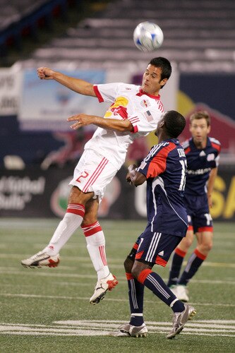 EAST RUTHERFORD, NJ - SEPTEMBER 18: Kheli Dube #11 of the New England Revolution defends as Mike Petke #12 of the New York Red Bull heads the ball away during their game at Giants Stadium on September 18, 2009 in East Rutherford, New Jersey. The Red Bulls and the Revolution played to a 1-1 tie.  <br /><br /><span class="help">(Photo by Andy Marlin/Getty Images for New York Red Bulls)</span>