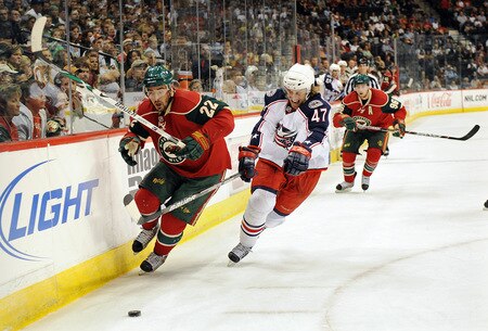 ST. PAUL, MN - SEPTEMBER 18: Cal Clutterbuck #22 of the Minnesota Wild chases the puck as Jonathan Sigalet #47of the Columbus Blue Jackets defends during the first period in a preseason game on September 18, 2009 at the Xcel Energy Center in St. Paul, Minnesota. <br /><br /><span class="help">(Photo by Tom Dahlin/Getty Images)</span>