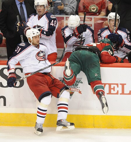 ST. PAUL, MN - SEPTEMBER 18: Fedor Tyutin #51 of the Columbus Blue Jackets checks Colton Gillies #18 of the Minnesota Wild into th visitors bench during the third period in a preseason game on September 18, 2009 at the Xcel Energy Center in St. Paul, Minnesota. <br /><br /><span class="help">(Photo by Tom Dahlin/Getty Images)</span>