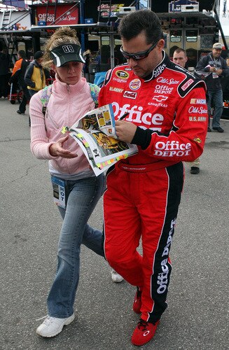 LOUDON, NH - SEPTEMBER 19:  Tony Stewart, driver of the #14 Office Depot/Old Spice Chevrolet, signs a autograph for a fan during practice for the NASCAR Sprint Cup Series Sylvania 300 at the New Hampshire Motor Speedway on September 19, 2009 in Loudon, New Hampshire  <br /><br /><span class="help">(Photo by Jim McIsaac/Getty Images for NASCAR)</span>