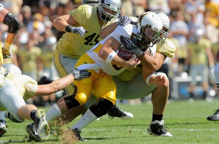 BOULDER, CO - SEPTEMBER 19:  Quarterback Austyn Carta-Samuels #5 of the Wyoming Cowboys is tackled by Taj Kaynor #97 of the Colorado Buffaloes at Folsom Field on September 19, 2009 in Boulder, Colorado.  <br /><br /><span class="help">(Photo by Doug Pensinger/Getty Images)</span>
