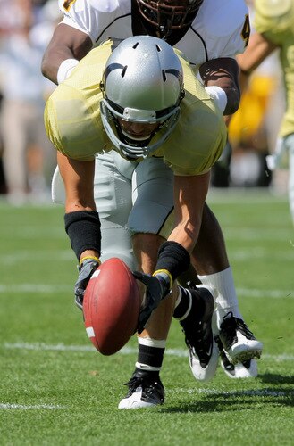 BOULDER, CO - SEPTEMBER 19:  Wide reciever Scotty McKnight #21 of the Colorado Buffaloes picks up a fumble by teammate Demetrius Sumler to score a first quarter touchdown against the Wyoming Cowboys at Folsom Field on September 19, 2009 in Boulder, Colorado.  <br /><br /><span class="help">(Photo by Doug Pensinger/Getty Images)</span>