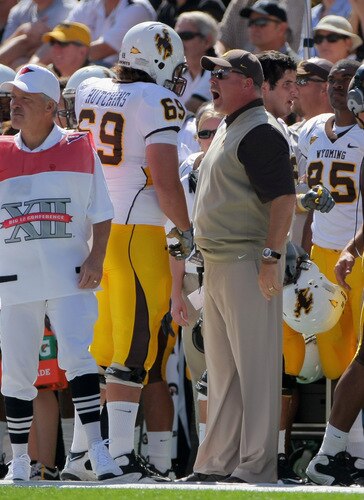 BOULDER, CO - SEPTEMBER 19:  Head coach Dave Christensen of the Wyoming Cowboys has words with right tackle John Hutchins #69 after he was called for illegal motion against the Colorado Buffaloes at Folsom Field on September 19, 2009 in Boulder, Colorado.  <br /><br /><span class="help">(Photo by Doug Pensinger/Getty Images)</span>