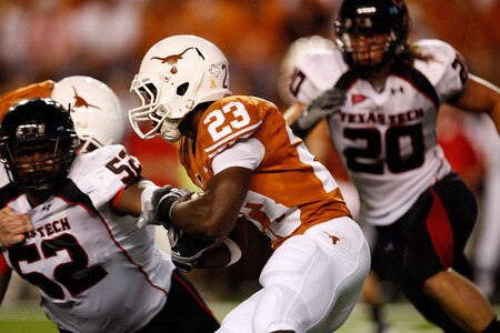 AUSTIN, TX - SEPTEMBER 19:  Running back Tre' Newton #23 of the Texas Longhorns runs the ball against Victor Hunter #52 of the Texas Tech Red Raiders at Darrell K Royal-Texas Memorial Stadium on September 19, 2009 in Austin, Texas.  <br /><br /><span class="help">(Photo by Ronald Martinez/Getty Images)</span>