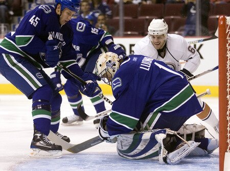 VANCOUVER, CANADA - SEPTEMBER 19: Goalie Roberto Luongo #1 of the Vancouver Canucks covers up the puck while defenceman Nathan McIver #45 of the Canucks and Gilbert Brule #67 of the Edmonton Oilers look for a loose puck during the first period of NHL preseason action on September 19, 2009 at General Motors Place in Vancouver, British Columbia, Canada.  <br /><br /><span class="help">(Photo by Rich Lam/Getty Images)</span>