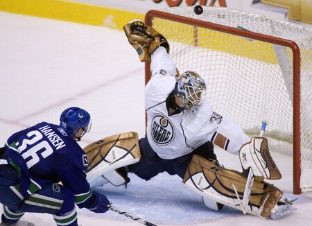 VANCOUVER, CANADA - SEPTEMBER 19: Goalie Jeff Deslauriers #38 of the Edmonton Oilers stops Jannik Hansen #36 of the Vancouver Canucks in close during the second period of NHL preseason action on September 19, 2009 at General Motors Place in Vancouver, British Columbia, Canada.  <br /><br /><span class="help">(Photo by Rich Lam/Getty Images)</span>