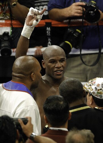 LAS VEGAS - SEPTEMBER 19:  Floyd Mayweather Jr. (L) celebrates his unanimous decision victory over Juan Manuel Marquez during their bout at the MGM Grand Garden Arena September 19, 2009 in Las Vegas, Nevada.  <br /><br /><span class="help">(Photo by Eric Jamison/Getty Images)</span>