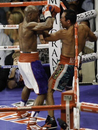 LAS VEGAS - SEPTEMBER 19:  Floyd Mayweather Jr. (L) exchanges punches with Juan Manuel Marquez during their bout at the MGM Grand Garden Arena September 19, 2009 in Las Vegas, Nevada. Mayweather won by unanimous decision.  <br /><br /><span class="help">(Photo by Eric Jamison/Getty Images)</span>