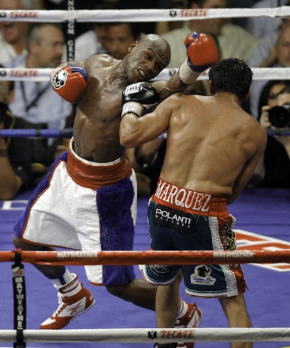LAS VEGAS - SEPTEMBER 19:  Floyd Mayweather Jr. (L) exchanges punches with Juan Manuel Marquez during their bout at the MGM Grand Garden Arena September 19, 2009 in Las Vegas, Nevada. Mayweather won by unanimous decision.  <br /><br /><span class="help">(Photo by Eric Jamison/Getty Images)</span>