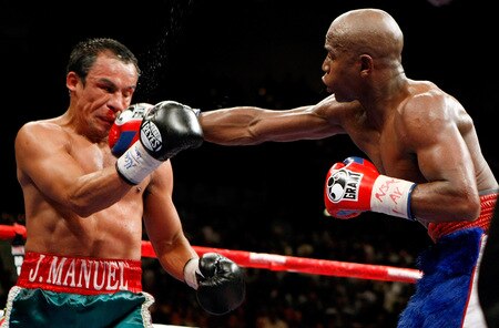 LAS VEGAS - SEPTEMBER 19:  Floyd Mayweather Jr. (R) hits Juan Manuel Marquez in the eighth round of their fight at the MGM Grand Garden Arena September 19, 2009 in Las Vegas, Nevada. Mayweather won by unanimous decision.  <br /><br /><span class="help">(Photo by Ethan Miller/Getty Images)</span>
