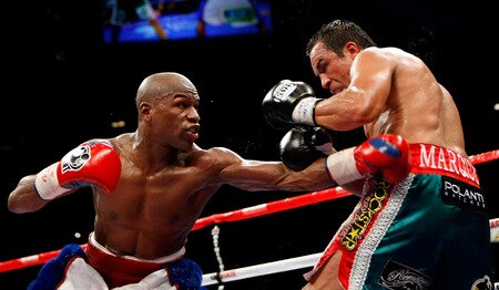 LAS VEGAS - SEPTEMBER 19:  Floyd Mayweather Jr. (L) throws a punch at Juan Manuel Marquez in the seventh round of their fight at the MGM Grand Garden Arena September 19, 2009 in Las Vegas, Nevada. Mayweather won by unanimous decision.  <br /><br /><span class="help">(Photo by Ethan Miller/Getty Images)</span>