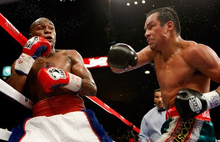 LAS VEGAS - SEPTEMBER 19:  Floyd Mayweather Jr. (L) and Juan Manuel Marquez exchange blows in the fourth round of their fight at the MGM Grand Garden Arena September 19, 2009 in Las Vegas, Nevada. Mayweather won by unanimous decision.  <br /><br /><span class="help">(Photo by Ethan Miller/Getty Images)</span>