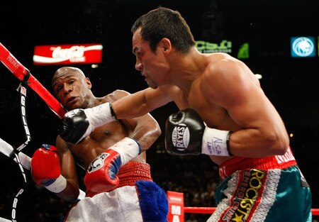 LAS VEGAS - SEPTEMBER 19:  Juan Manuel Marquez (R) throws a punch at Floyd Mayweather Jr. during their fight at the MGM Grand Garden Arena September 19, 2009 in Las Vegas, Nevada. Mayweather won by unanimous decision.  <br /><br /><span class="help">(Photo by Ethan Miller/Getty Images)</span>
