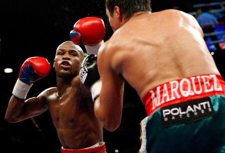 LAS VEGAS - SEPTEMBER 19:  Floyd Mayweather Jr. (L) throws a punch at Juan Manuel Marquez in the fourth round of their fight at the MGM Grand Garden Arena September 19, 2009 in Las Vegas, Nevada. Mayweather won by unanimous decision.  <br /><br /><span class="help">(Photo by Ethan Miller/Getty Images)</span>