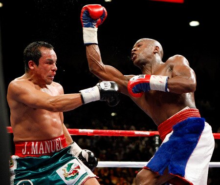 LAS VEGAS - SEPTEMBER 19:  Floyd Mayweather Jr. (R) throws a punch at Juan Manuel Marquez in the sixth round of their fight at the MGM Grand Garden Arena September 19, 2009 in Las Vegas, Nevada. Mayweather won by unanimous decision.  <br /><br /><span class="help">(Photo by Ethan Miller/Getty Images)</span>