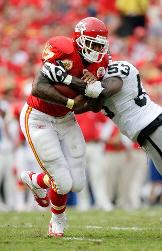 KANSAS CITY, MO - SEPTEMBER 20:  Running back Larry Johnson #27 of the Kansas City Chiefs carries the ball as Thomas Howard #53 of the Oakland Raiders defends during the game at Arrowhead Stadium on September 20, 2009 in Kansas City, Missouri.  <br /><br /><span class="help">(Photo by Jamie Squire/Getty Images)</span>